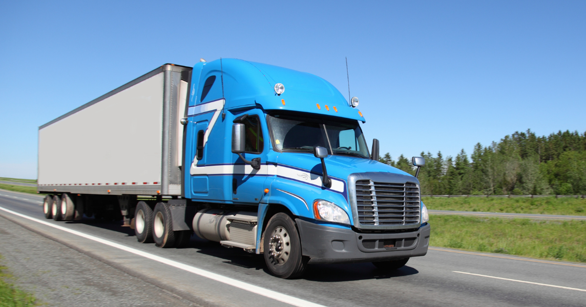 Blue semi-truck on highway representing diesel ECM repair for heavy-duty engines