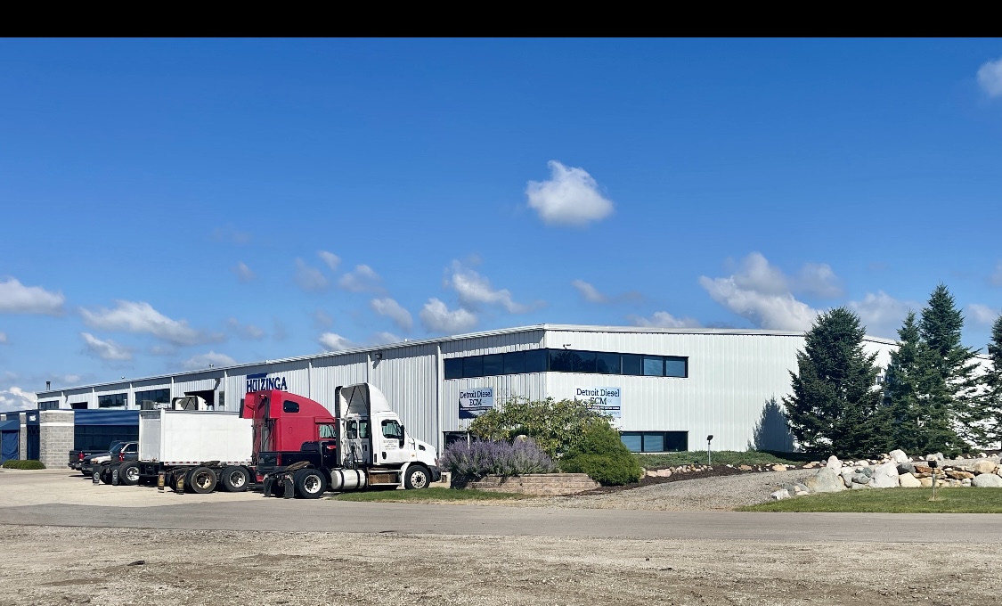 Diesel ECM Technology specialist facility in Wayland, MI with semi-trucks outside, providing expert diesel ECM repair, programming, and remanufacturing services