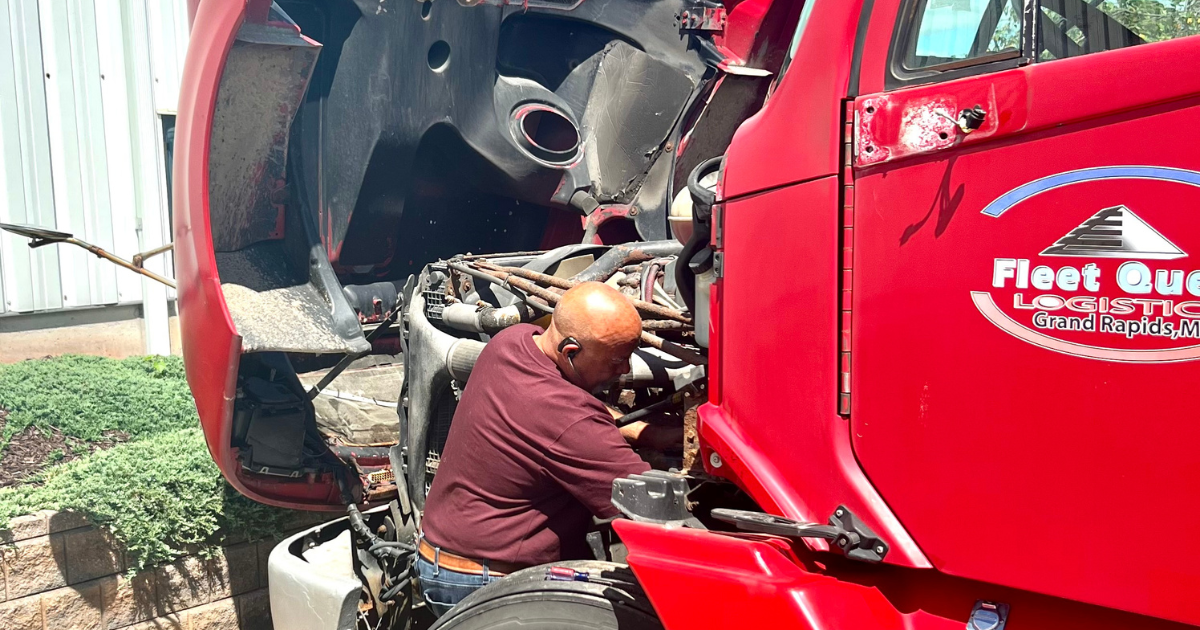 Diesel mechanic performing ECM repair on semi truck engine diagnosing control module issues